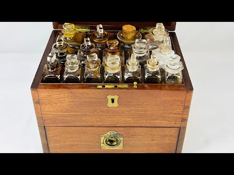 Antique Victorian apothecary box crafted in mahogany with brass fittings, containing original glass bottles with labels, balance scales, mortar and pestle, and chemist’s tools, late 19th century.