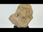 Terracotta fragment of a stylized anthropomorphic figure with almond-shaped eyes, prominent nose, and incised chest details, mounted on a modern wood base; likely from West Mexico (Nayarit or Jalisco) or Iberian/Roman provincial context, circa 200 BCE–2nd Century CE.