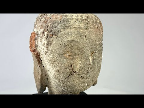 Ancient terracotta Buddha head from Southeast Asia, circa 5th–10th century CE, with serene facial features, weathered surface, and mounted display stand.