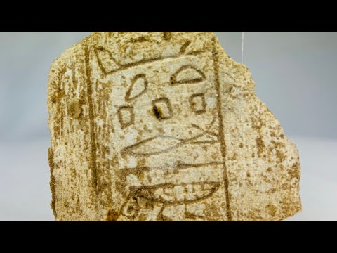 Ancient Egyptian hand-carved limestone fragment with clear hieroglyphic inscriptions, Late Period circa 700 BCE, showing symbols including loaf, water ripple, and eye motif, mounted on modern display base for study and exhibition.
