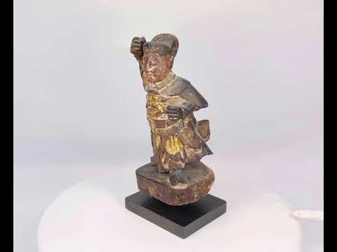 Carved and painted Qing Dynasty wooden statue of Wei Tuo Pusa (Skanda), 11 inches tall, depicting a warrior guardian with intricate armor, traces of red, gold, and black pigment, mounted on a black wooden base, Early 19th Century.