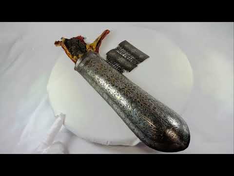 Mini documentary showcasing an 18th-century Qajar Persian warrior’s Bazu-Band arm guard, featuring engraved gold koftgari steel, original chain mail sections, and textile lining, presented by Relic & Rarity.