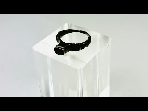 Authentic Roman bronze signet ring, circa 100–300 CE, with rounded band and flat bezel once engraved for sealing documents. Worn smooth from centuries of use, with deep green-black patina and earthen encrustations, a tangible relic of Roman identity.