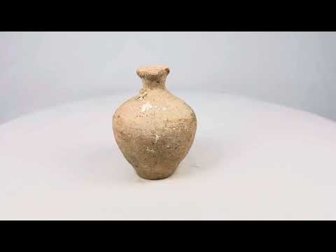 Roman terracotta juglet, 1st–3rd century CE, with rounded body, narrow neck, and flared rim, used for storing and pouring oils or perfumes, with natural aged patina.