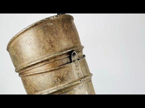 Renaissance knight’s upper arm defense, 16th-century cannon-style armor plate with riveted bands, aged surface, and mounted for display.
