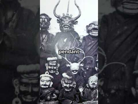 Mini documentary video showcasing a mid-20th century Tibetan protective shrine mask ornament with skull-like guardian face, leather backing, cord suspension, and amber-tone ritual drop.