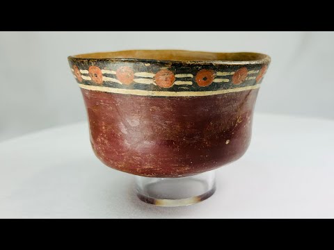 Early Nazca terracotta bowl, circa 100–300 AD, with flared rim and vibrant polychrome decoration of red circular and black-cream geometric motifs, reflecting pre-Columbian ceremonial artistry.