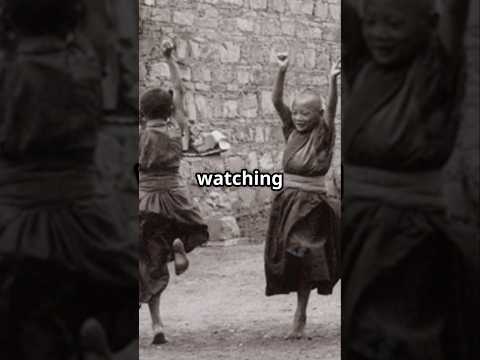 Short documentary-style video showing a carved Chinese stone head of a Buddhist Arhat (Luohan) from the Qing Dynasty, displayed on a black stand and filmed from multiple angles to highlight the sculpture’s facial features, elongated ears, and traces of polychrome pigment.