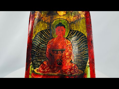 Antique Qing Dynasty Tibetan bone plaque, vividly painted with a seated Buddha in red and gold polychrome, framed by radiant aureole and floral motifs; portable devotional amulet used in Buddhist ritual practice, exhibiting aged surface wear and patina consistent with 19th century craftsmanship.