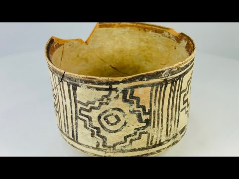 Indus Valley painted pottery vessel, 3rd millennium BCE, cylindrical form with black geometric motifs on cream surface and aged patina.