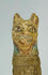 Close-up of the painted feline head from an Ancient Egyptian cat mummy votive offering.