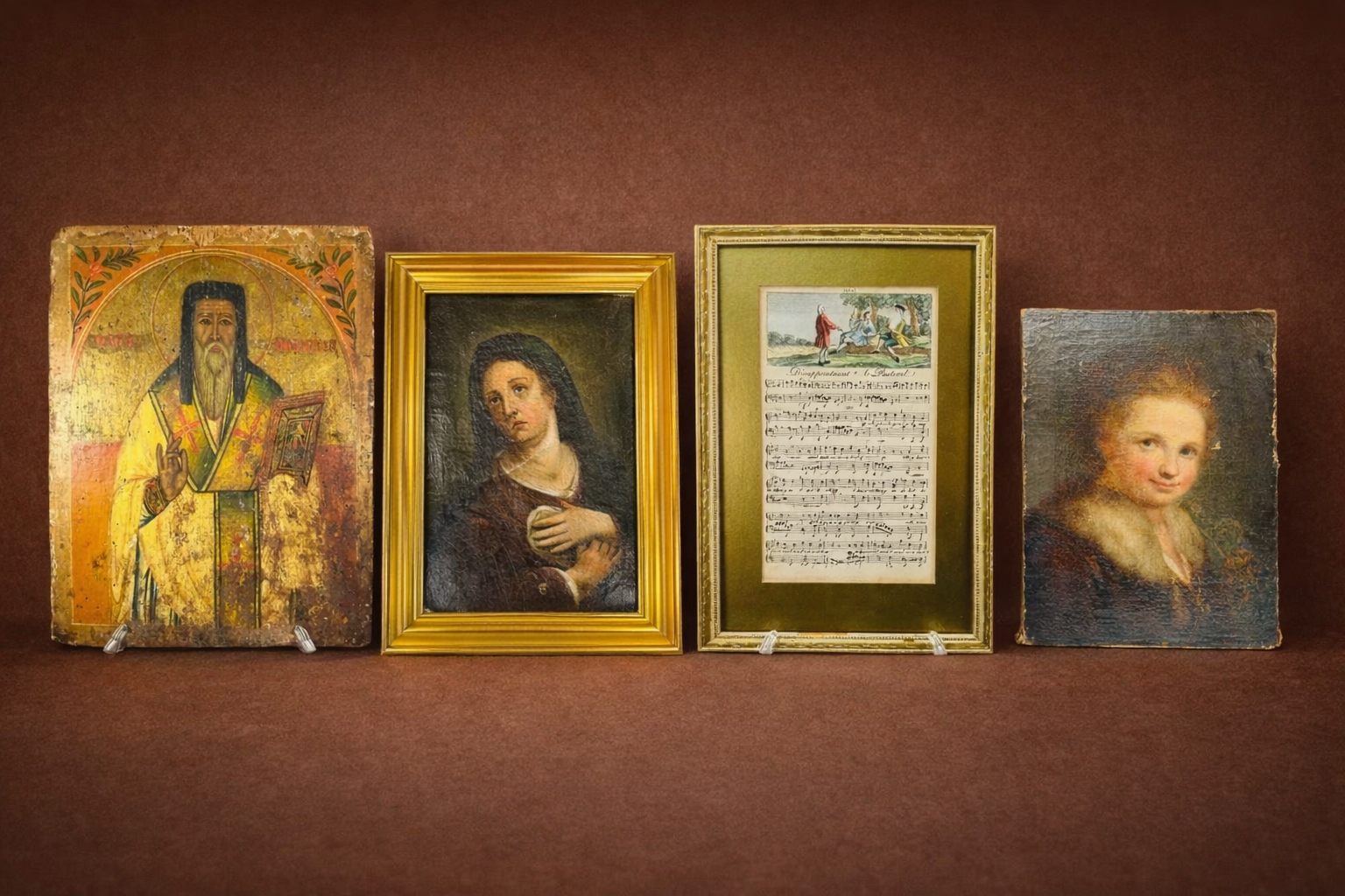 Professional horizontal gallery photograph featuring four antique European artworks — an 18th-century Russian religious icon, framed oil painting of the Virgin Mary in mourning, Georgian-era hand-colored sheet music engraving, and an antique European portrait of a young woman — displayed against a warm museum-style brown backdrop.