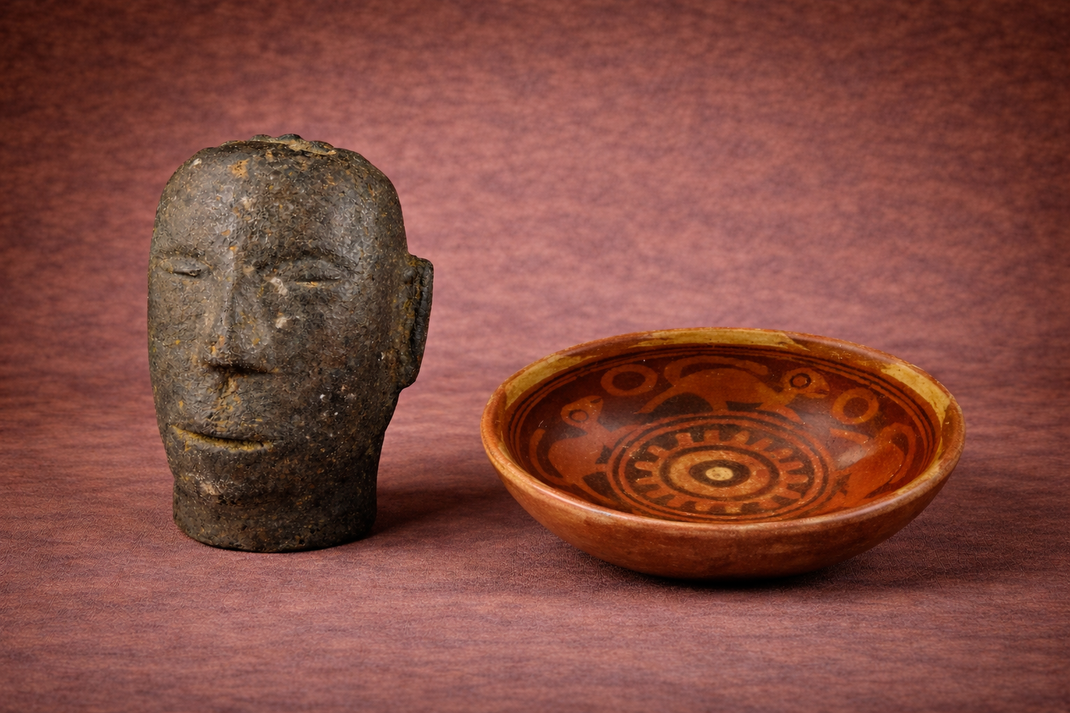 Pre-Columbian ceramic head sculpture and painted pottery bowl displayed by Relic & Rarity