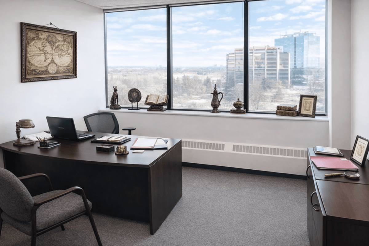 Private office at Relic & Rarity gallery featuring curated historical artifacts displayed along a window ledge overlooking the city skyline.