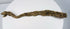 Ancient Egyptian animal mummy with curved crocodile form and extensive surviving linen wrapping