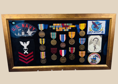 Framed U.S. Navy veteran shadow box featuring medals, patches, ribbon bars, and portrait photograph