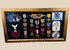 Framed U.S. Navy veteran shadow box featuring medals, patches, ribbon bars, and portrait photograph