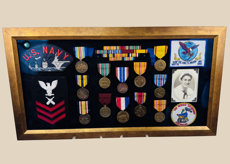 Framed U.S. Navy veteran shadow box featuring medals, patches, ribbon bars, and portrait photograph