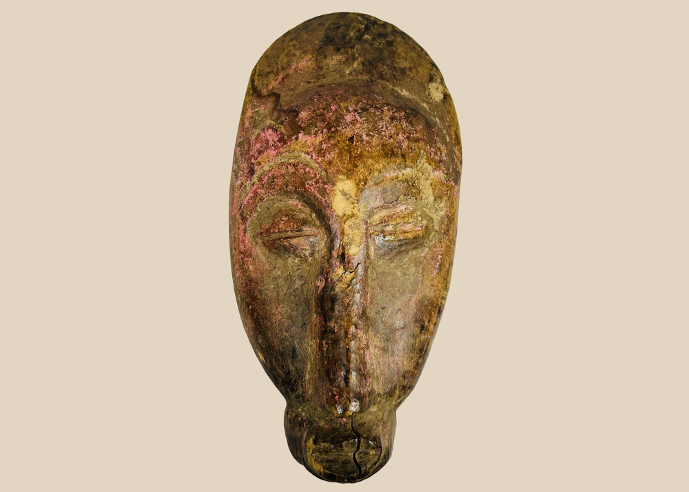 West African Baule style wooden mask with elongated face and pigment